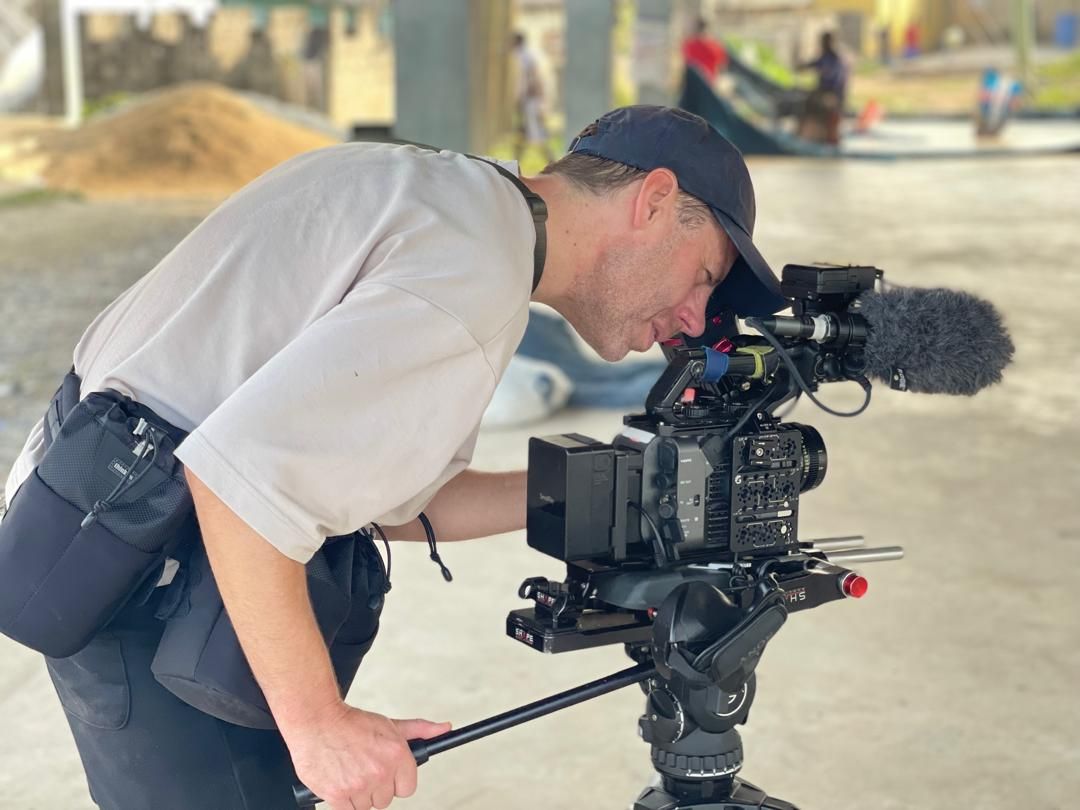 Close-up of the cameraman filming on location in Dixcove