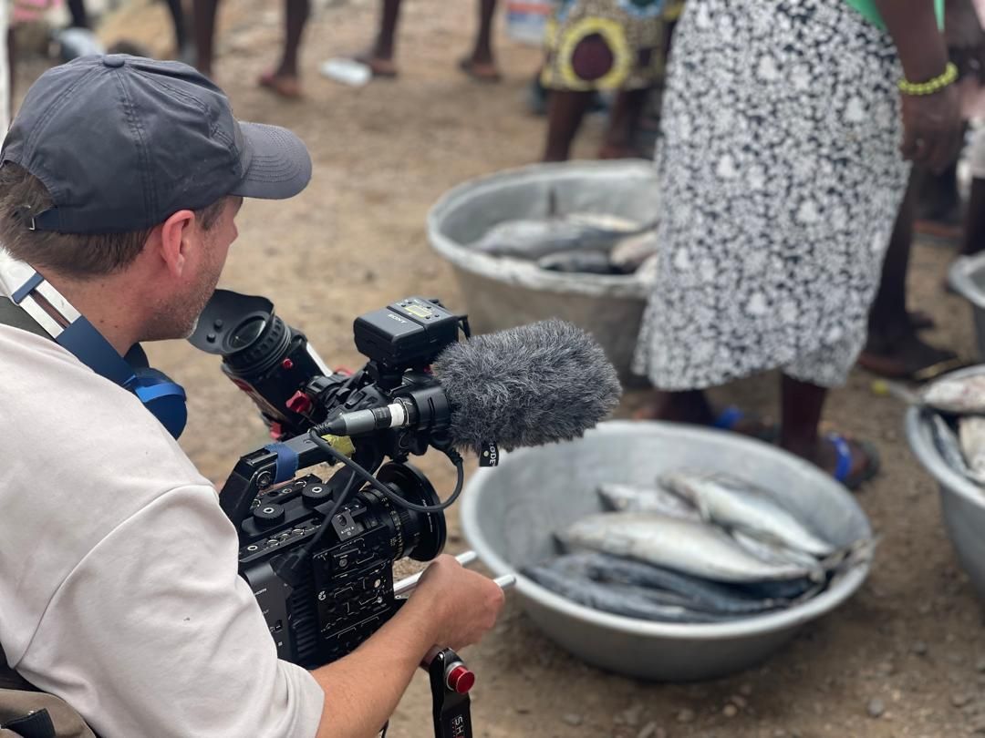 Crew filming the day's catch at the Dixcove fish market