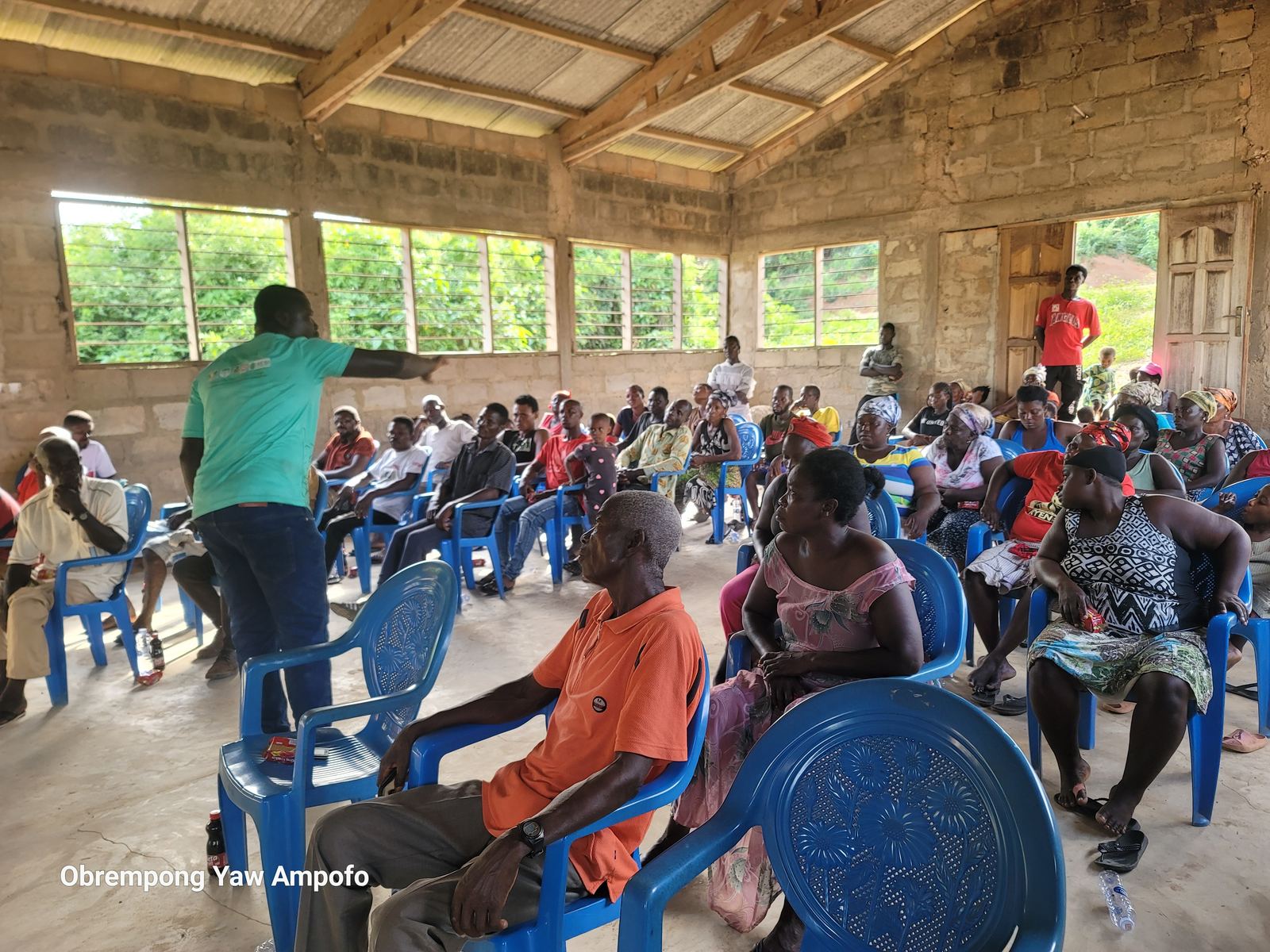 Facilitator briefing a packed community hall in the Ewoyaa lithium catchment area